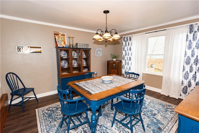 dining room with dark wood-type flooring, ornamental molding, a chandelier, and baseboards
