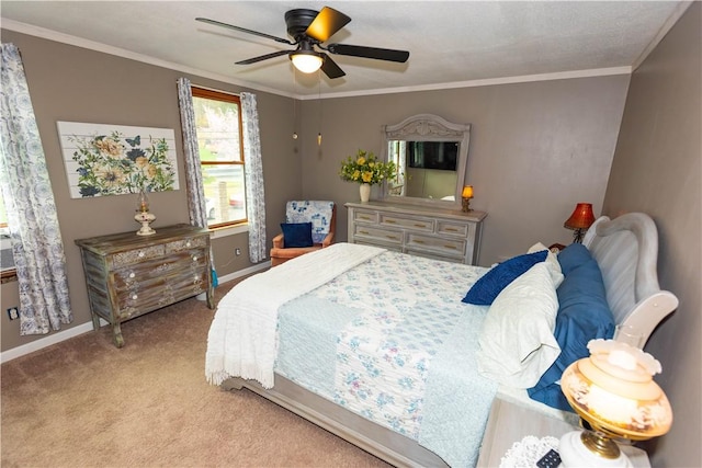 bedroom with carpet, baseboards, crown molding, and ceiling fan