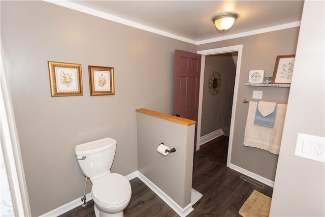 bathroom featuring wood finished floors, toilet, and baseboards