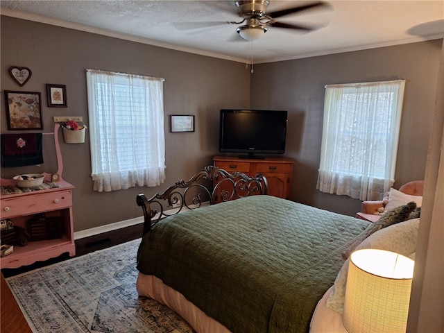 bedroom with wood finished floors, baseboards, ceiling fan, and ornamental molding