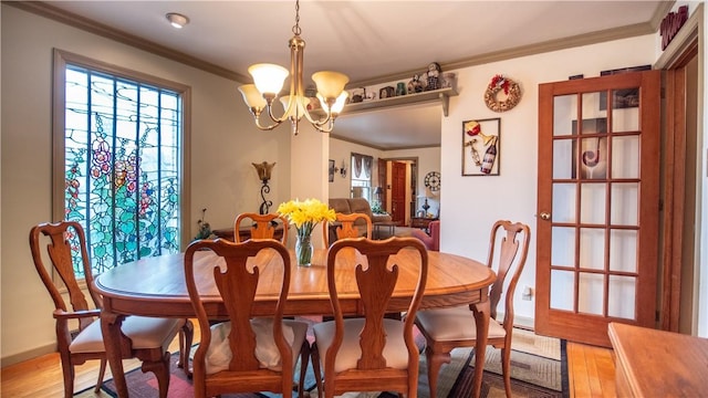612 Freeport Rd, South Buffalo Twp, PA 16229 - dining space with crown molding, a chandelier, light wood-type flooring, and baseboards