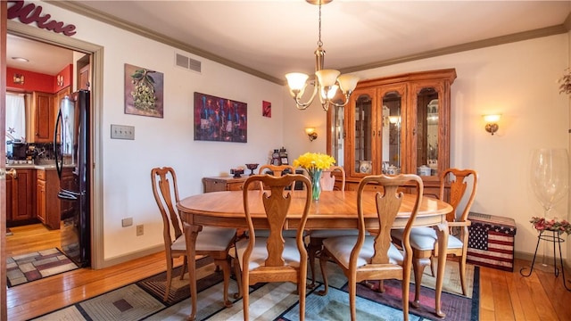 612 Freeport Rd, South Buffalo Twp, PA 16229 - dining room with crown molding, light wood-style flooring, and a chandelier