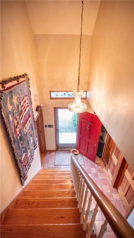 612 Freeport Rd, South Buffalo Twp, PA 16229 - staircase featuring a chandelier and high vaulted ceiling
