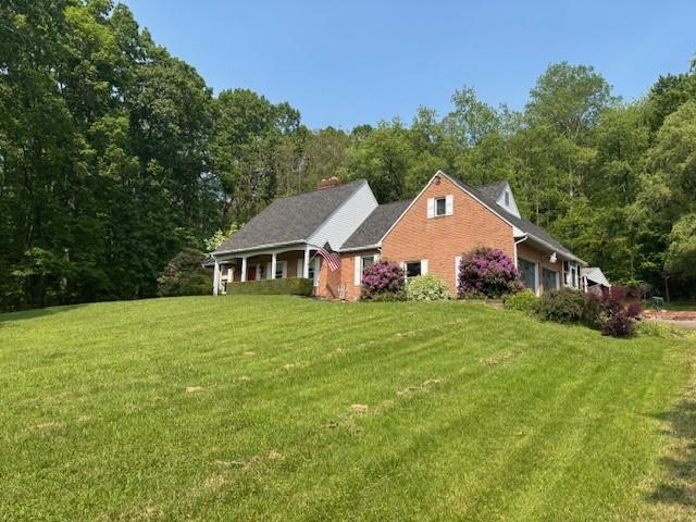 612 Freeport Rd, South Buffalo Twp, PA 16229 - view of side of home with a lawn, a view of trees, and a chimney