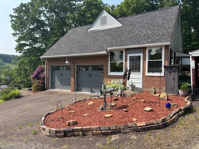 612 Freeport Rd, South Buffalo Twp, PA 16229 - view of front of house with roof with shingles, brick siding, asphalt driveway, and an attached garage