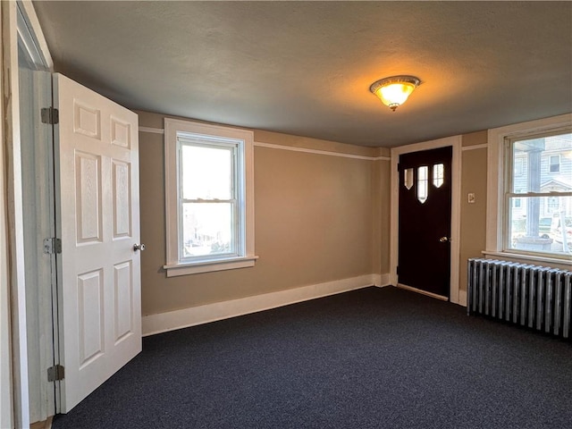 528 3rd St, Charleroi Boro, PA 15022 - entryway featuring radiator, baseboards, dark colored carpet, and a textured ceiling