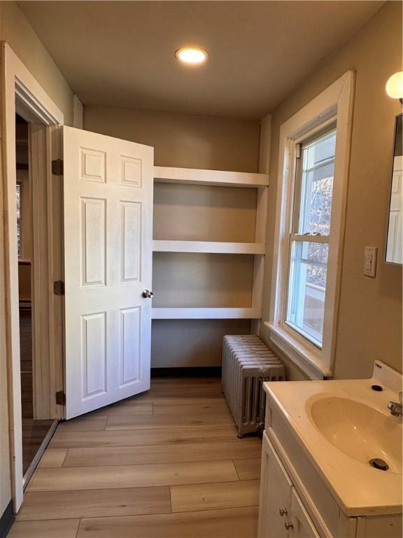 528 3rd St, Charleroi Boro, PA 15022 - bathroom with wood finished floors, radiator heating unit, recessed lighting, and vanity