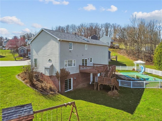 back of house with a yard, a wooden deck, fence, and stairs