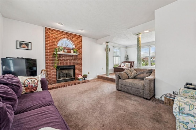 carpeted living room featuring decorative columns, a fireplace, and baseboards