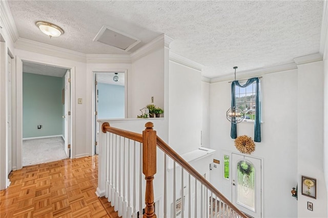114 Adella Ct, Penn Twp Wml, PA 15644 - hallway with a textured ceiling, baseboards, an upstairs landing, crown molding, and attic access