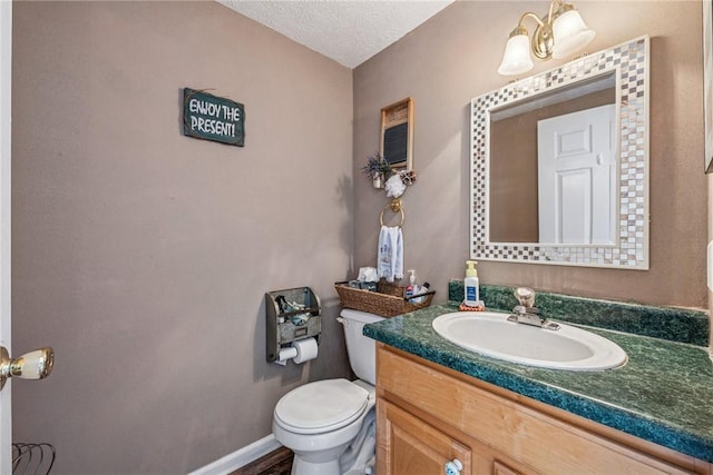 114 Adella Ct, Penn Twp Wml, PA 15644 - half bathroom with toilet, vanity, a textured ceiling, and baseboards
