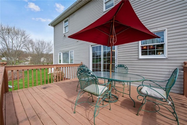 deck featuring a yard and outdoor dining space