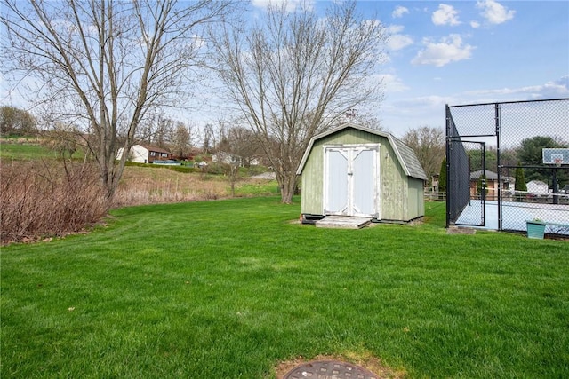 view of yard featuring a storage unit, fence, and an outdoor structure