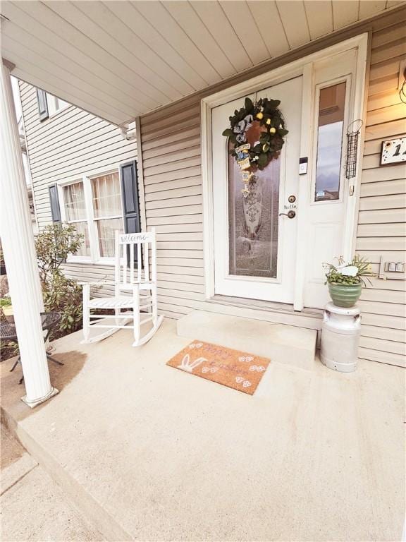 view of exterior entry featuring a porch