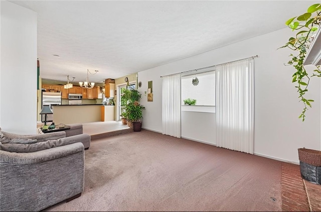 114 Adella Ct, Penn Twp Wml, PA 15644 - living area with light carpet, a chandelier, and baseboards