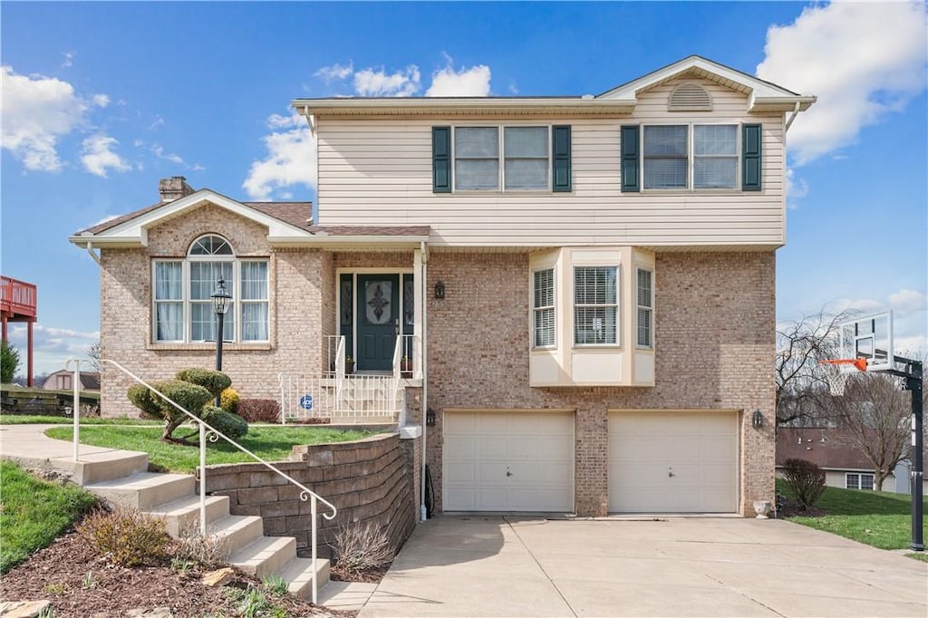 255 Mallard Dr, Monroeville, PA 15146 - view of front facade featuring driveway, brick siding, and an attached garage