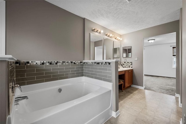 1768 Haflinger Dr, North Huntingdon, PA 15642 - bathroom featuring vanity, baseboards, a garden tub, and a textured ceiling