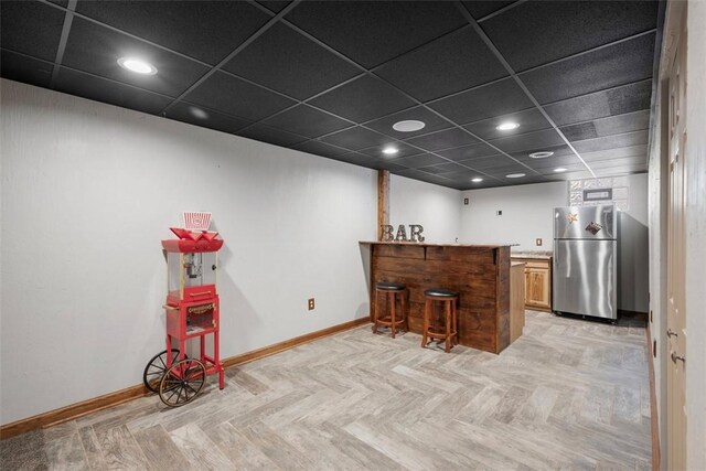 1768 Haflinger Dr, North Huntingdon, PA 15642 - interior space with freestanding refrigerator, recessed lighting, baseboards, a peninsula, and a kitchen bar