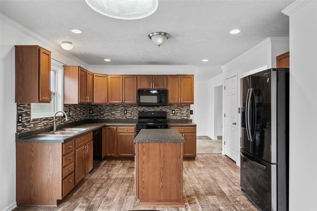 1768 Haflinger Dr, North Huntingdon, PA 15642 - kitchen featuring light wood-style floors, dark countertops, black appliances, and a center island