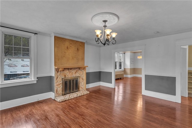 115 Powell St, Wilkins Twp, PA 15112 - unfurnished living room featuring a chandelier, wood finished floors, radiator, and baseboards