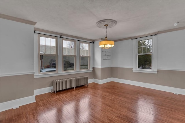 115 Powell St, Wilkins Twp, PA 15112 - unfurnished dining area featuring radiator, hardwood / wood-style floors, ornamental molding, and baseboards