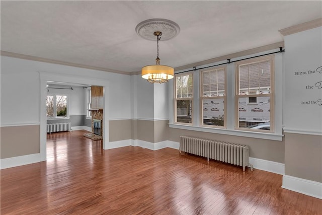 115 Powell St, Wilkins Twp, PA 15112 - unfurnished room with radiator, wood finished floors, baseboards, and crown molding