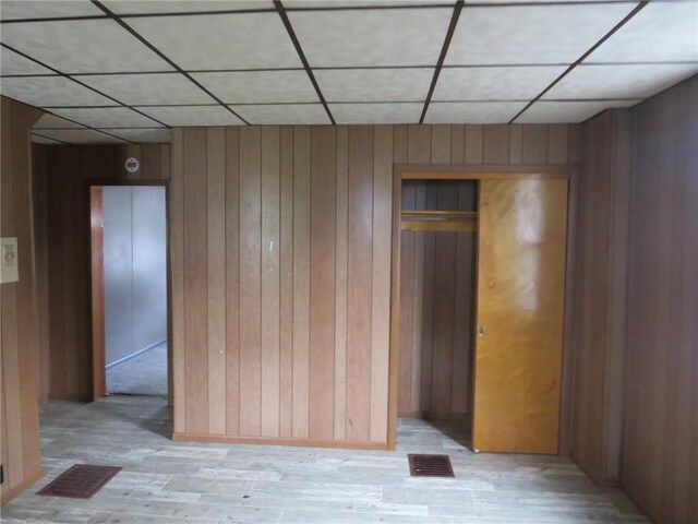 413 S 5th St, West Newton, PA 15089 - unfurnished room with wood walls, a paneled ceiling, and light wood-style floors