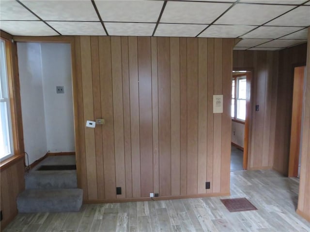 413 S 5th St, West Newton, PA 15089 - empty room featuring a drop ceiling, wooden walls, and light wood-type flooring