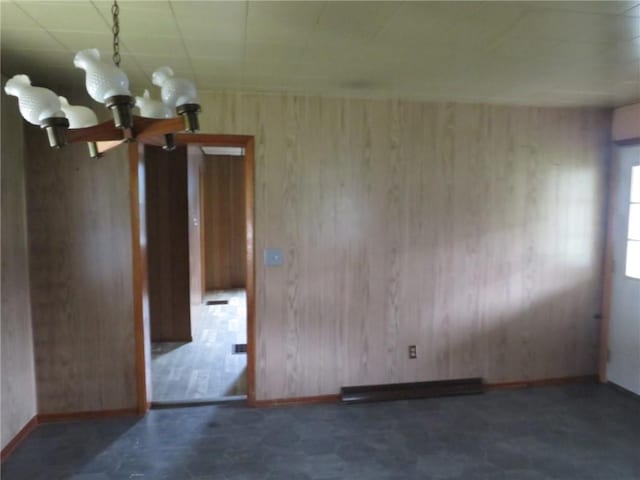 413 S 5th St, West Newton, PA 15089 - spare room featuring a chandelier, wooden walls, and tile patterned floors