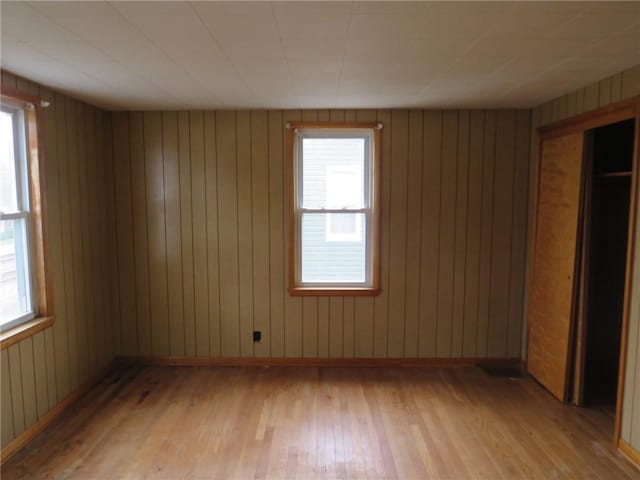 413 S 5th St, West Newton, PA 15089 - unfurnished bedroom with light wood finished floors, multiple windows, and wooden walls