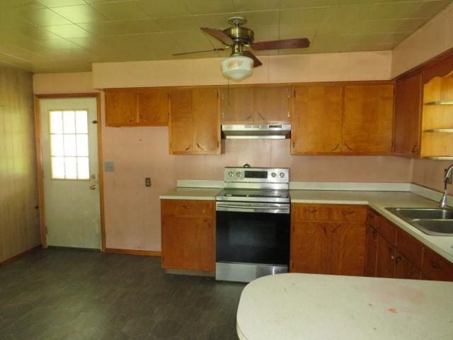 413 S 5th St, West Newton, PA 15089 - kitchen with stainless steel electric range, under cabinet range hood, brown cabinetry, and light countertops