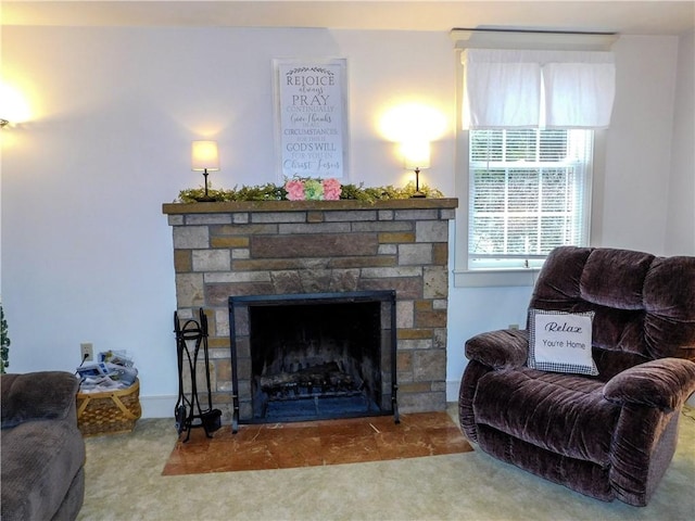 living room with carpet flooring and a stone fireplace