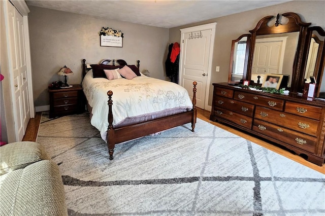 bedroom featuring baseboards and wood finished floors
