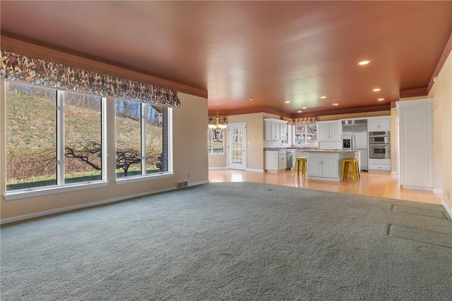 2036 Revere Dr, Connellsville, PA 15425 - unfurnished living room featuring a chandelier, recessed lighting, crown molding, and light colored carpet