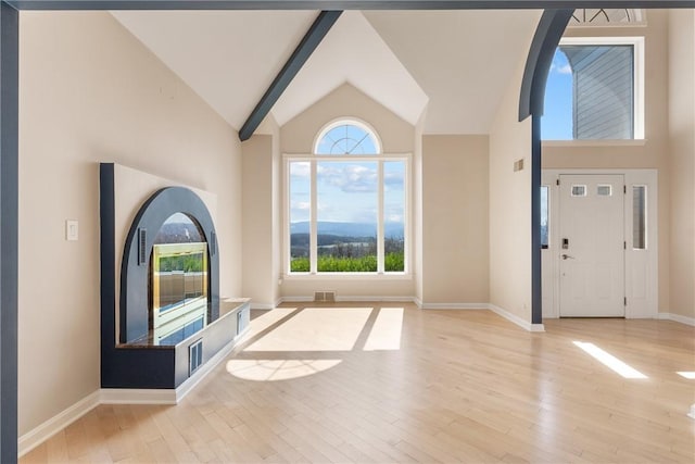 2036 Revere Dr, Connellsville, PA 15425 - unfurnished living room featuring healthy amount of natural light, wood finished floors, and high vaulted ceiling