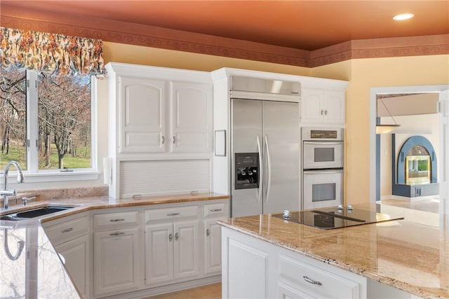 2036 Revere Dr, Connellsville, PA 15425 - kitchen featuring built in fridge, white double oven, black electric cooktop, white cabinetry, and recessed lighting