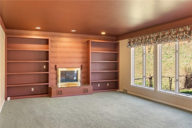 2036 Revere Dr, Connellsville, PA 15425 - unfurnished living room with a glass covered fireplace, recessed lighting, carpet, and built in shelves