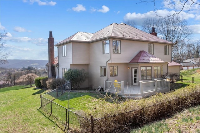 2036 Revere Dr, Connellsville, PA 15425 - back of property with a high end roof, a chimney, a wooden deck, and a fenced backyard