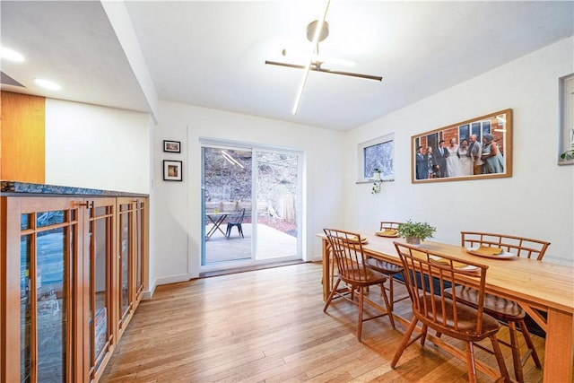 dining room featuring baseboards and light wood-type flooring