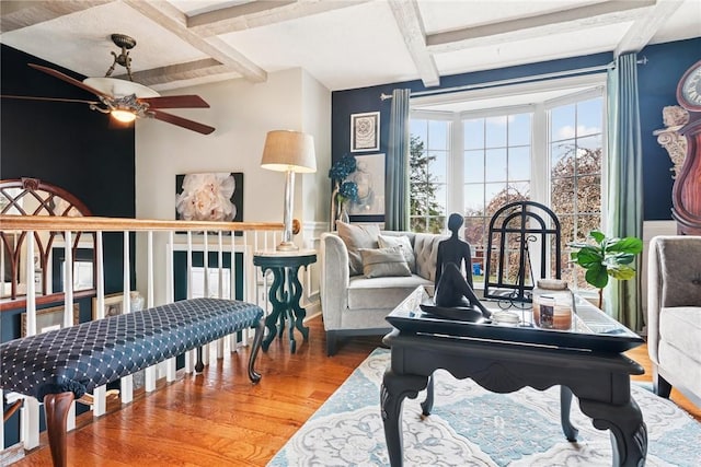 interior space featuring beamed ceiling, wood finished floors, and a ceiling fan