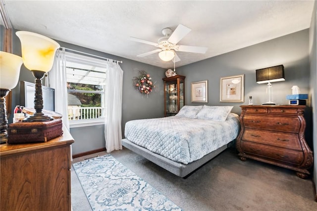 carpeted bedroom featuring baseboards and ceiling fan