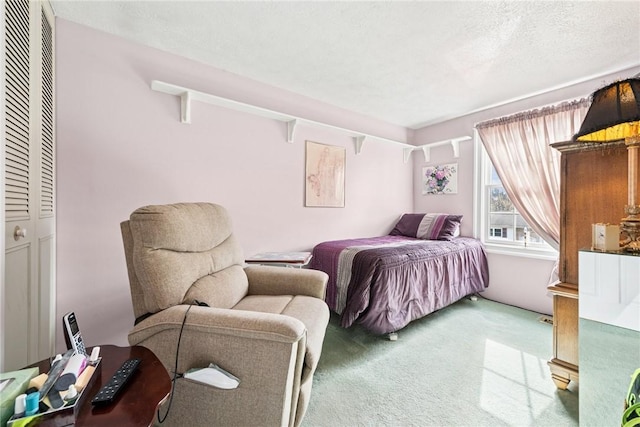 carpeted bedroom featuring a textured ceiling