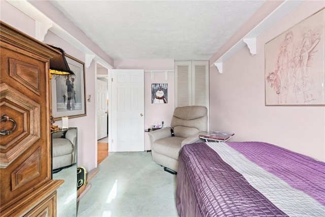 bedroom with carpet floors, a closet, and a textured ceiling