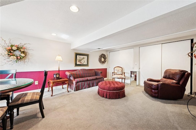 living room with carpet floors, recessed lighting, and a textured ceiling
