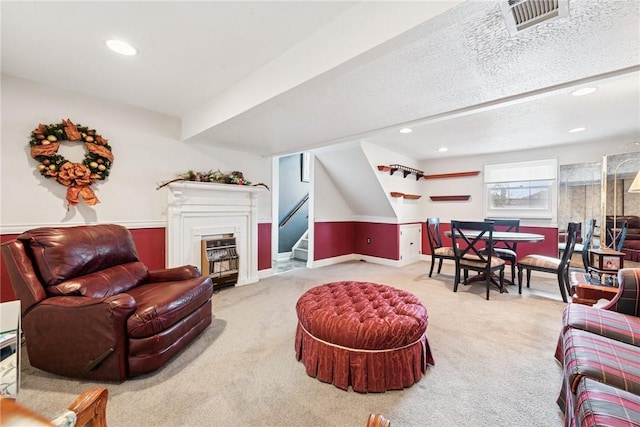 living room featuring carpet flooring, recessed lighting, stairs, and visible vents