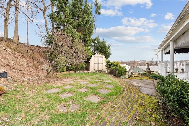 view of yard featuring a storage unit and an outdoor structure