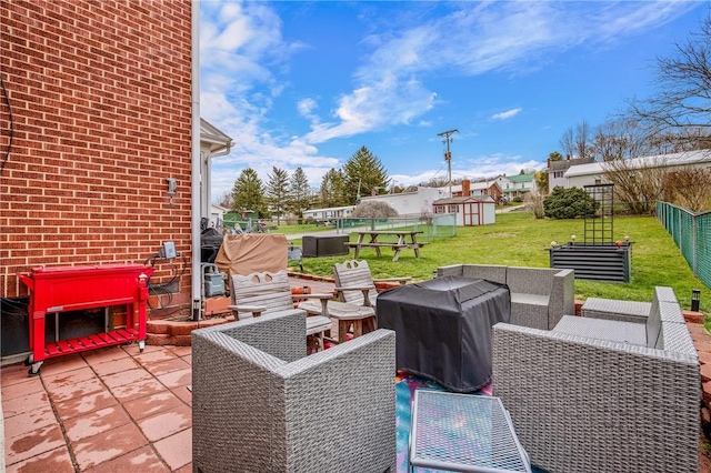 view of patio with an outdoor structure, a shed, fence, area for grilling, and outdoor lounge area