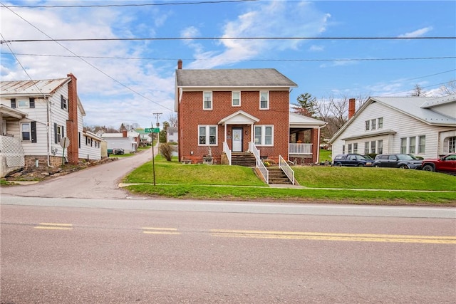 view of front of home with brick siding and a front lawn