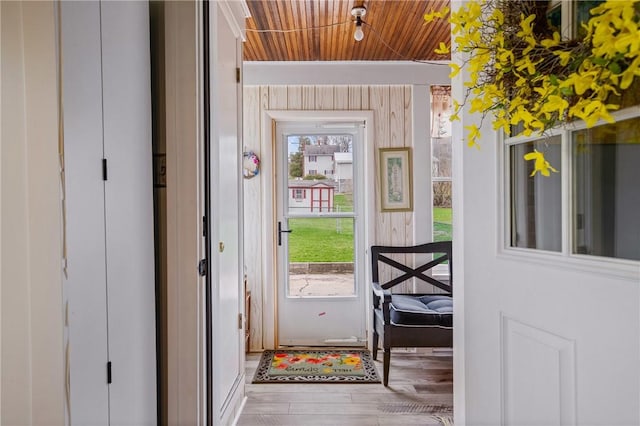 doorway to outside with wood finished floors and wood ceiling