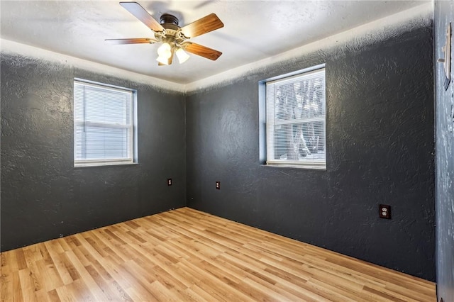 808 Thompson Run Rd, Springdale Twp, PA 15049 - empty room with a textured wall, wood finished floors, and ceiling fan